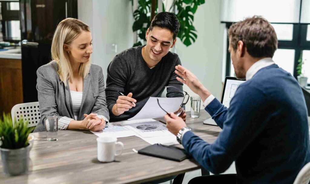 Fee-only financial advisors analyzing portfolio documents and comparison charts