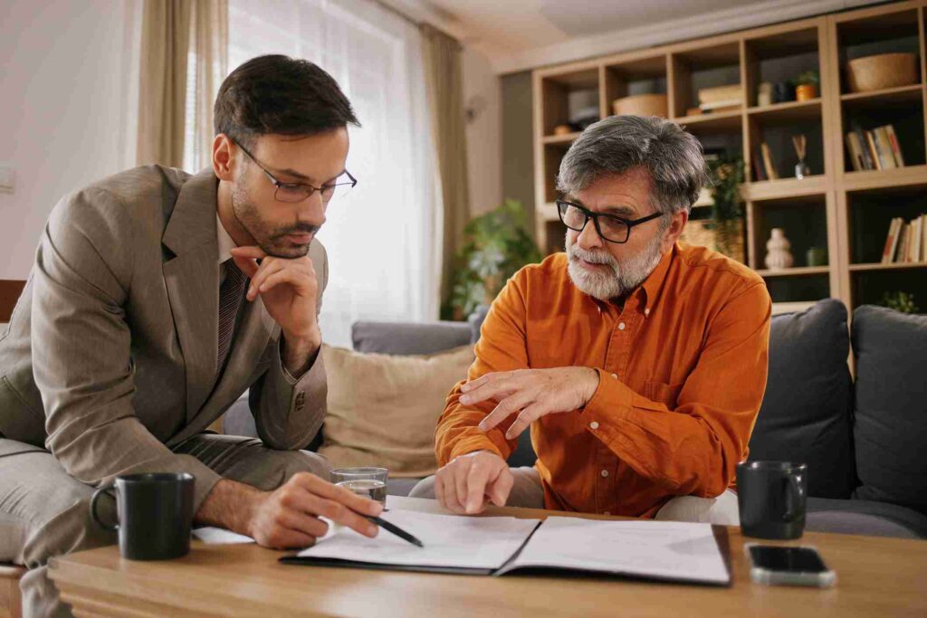 Advisor reviewing a financial document with a client at a coffee table